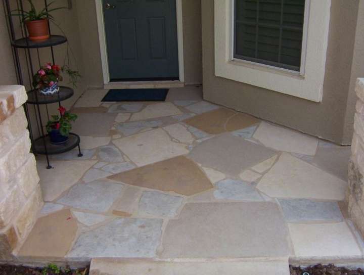 Flagstone landing and step at a back door with a plant stand