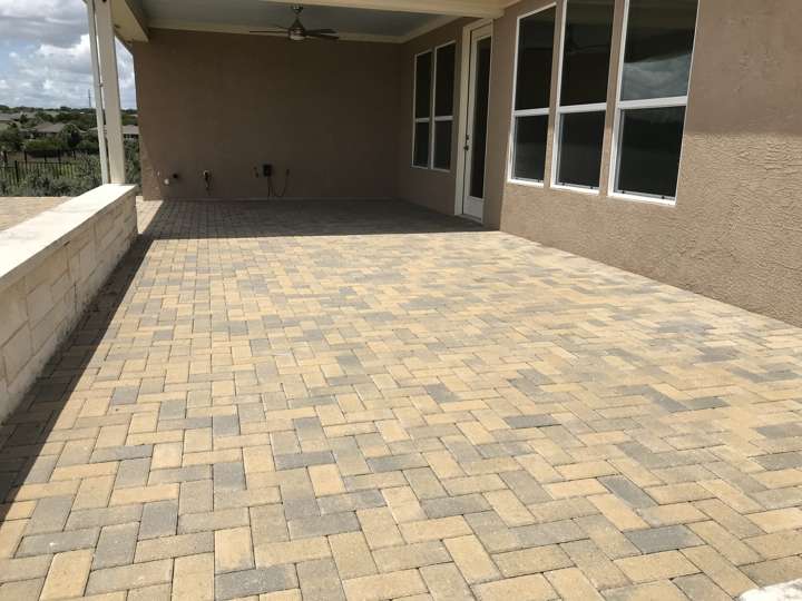 Paver patio in a mixed tan blend under a covered porch