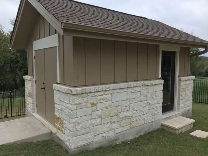 Shed with a chopped limestone base and a concrete step