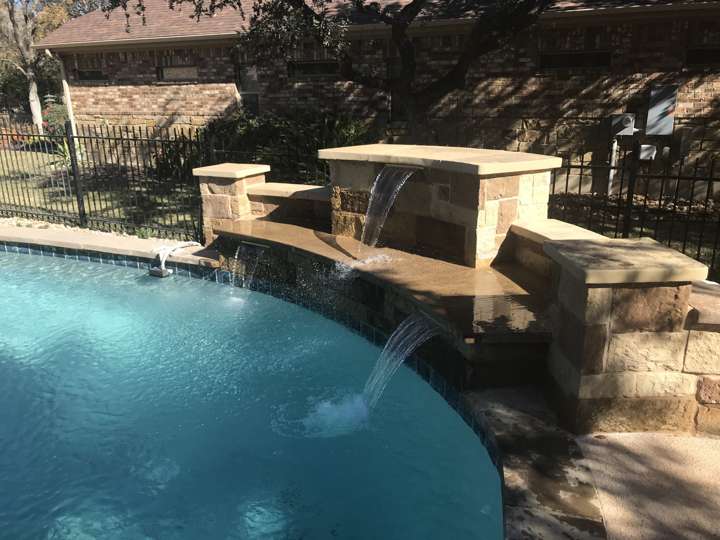 Stone waterfall feature spilling into a pool