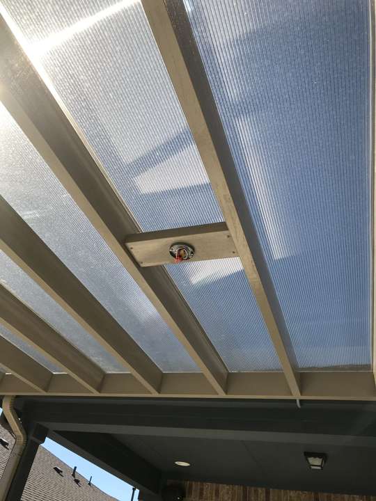 Underside of an aluminum pergola with lighting