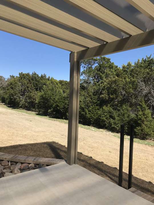 Freestanding pergola over a gravel patio