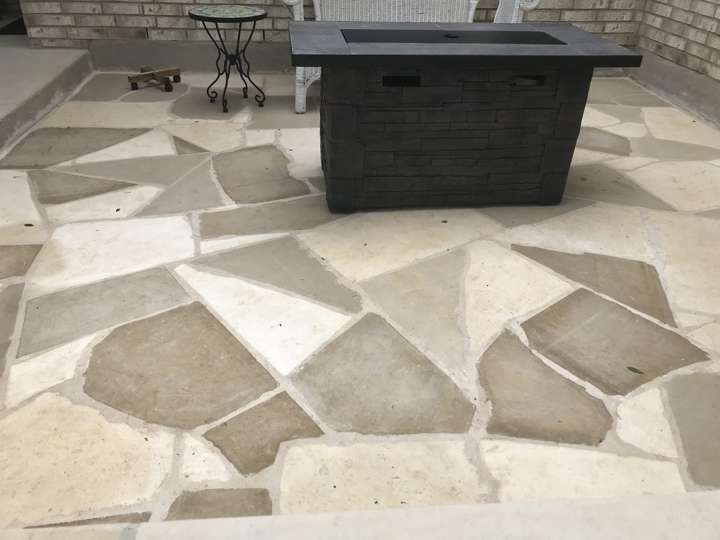 Flagstone patio with a square gas fire table