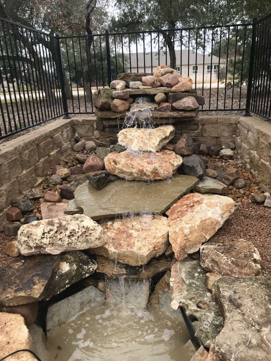 Stacked stone waterfall with a basin at the base