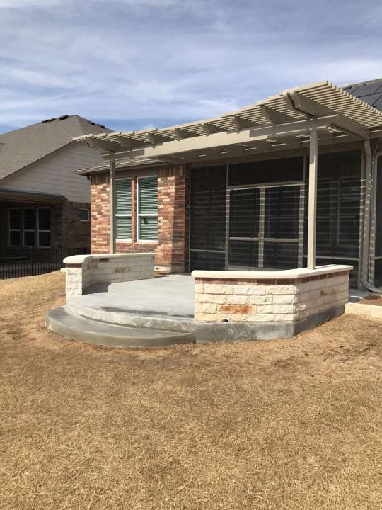 Limestone seat wall under a new pergola frame