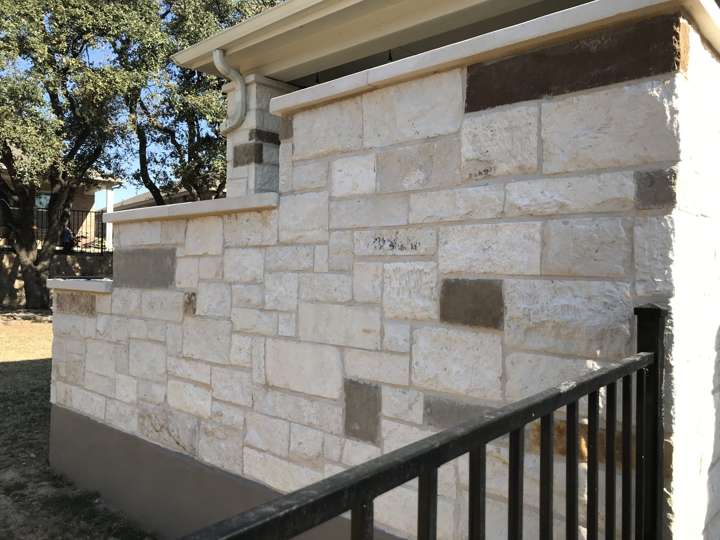 Limestone screen wall with dark stone accents