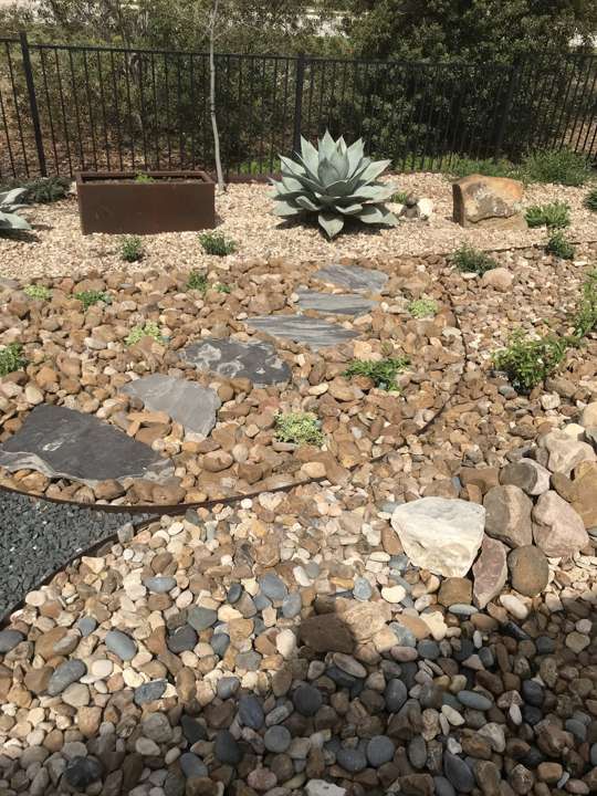 Gravel bed with flagstone steppers, boulders and an agave